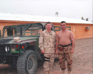 Scott Englund (left) standing in uniform next to a military Jeep with a fellow service member (right).
